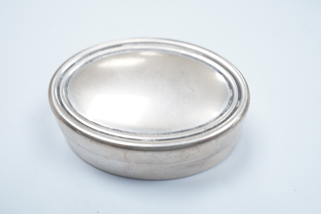 A continental 935 standard white metal oval box, with inset frosted glass and marcasite set hinged cover, 82mm, together with three assorted small pill boxes, including enamelled(a.f.), an Italian 800 standard and a mode